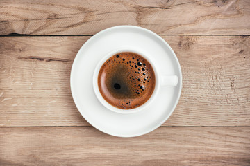 Coffee cup on rustic wooden table. 