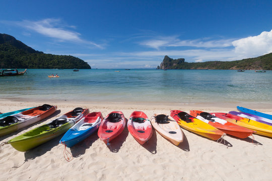 Colorful kayaks on the beach.
