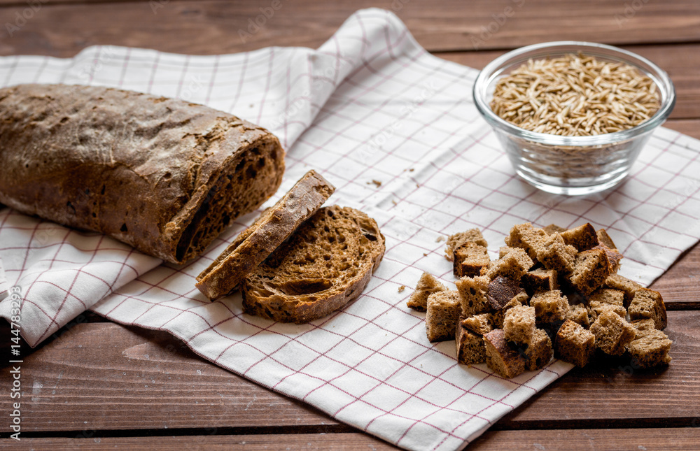 Wall mural traditional sliced bread with crumbs wooden table background