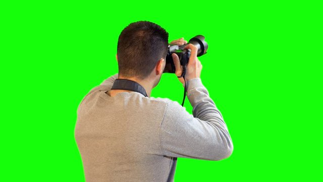 Greenscreen Photographer Following Subject with DSLR Camera and Taking Picture