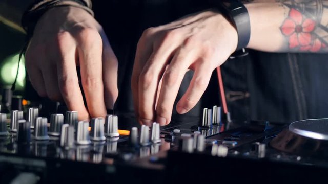 Male dj behind the turntables 4K.