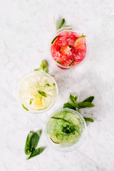 Fruit summer drinks with ice. Flat lay, top view.