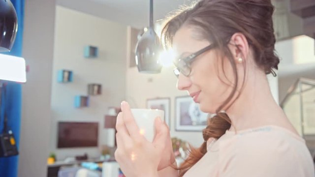 Pretty, calm woman holding a cup of coffee