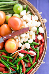 mixed vegetables in basket and knife