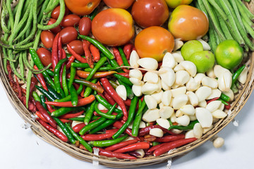 mixed vegetables in basket on white table
