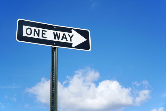 one way sign in front of blue sky and white cloud - Powered by Adobe