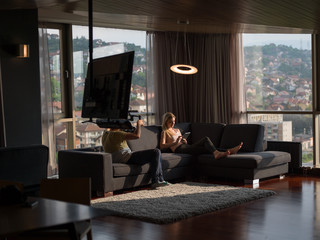 Woman Using Tablet On Couch At Home