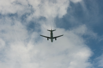 Fototapeta na wymiar Below view Airplane in the sky and cloud