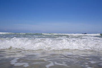 view of tropical beach with wave on the sunny sky. Summer paradise beach.