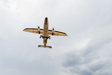 Airplane flys in the cloudy sky