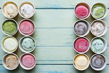 Top view Ice cream flavors in cup on wood background
