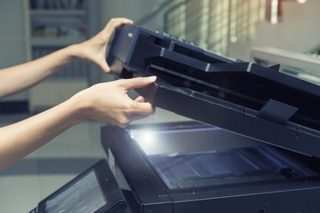 woman opening a copying device