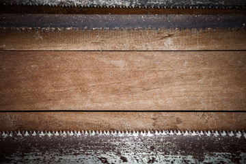 Grunge blade of saw on wood background with empty space for  text or brand.
