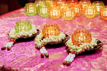Burning candles and ritual flowers in a Buddhist temple