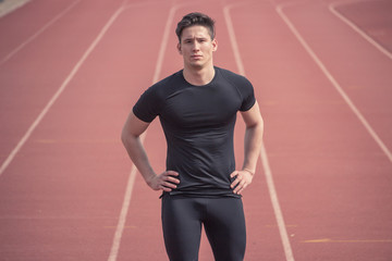 Obraz premium one young man, runner fitness athlete posing, running tracks