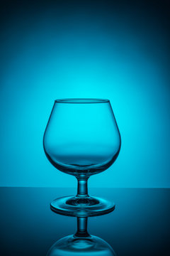 Empty wine glass on a blue  background