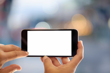 Smart phone showing blank screen in man hand at walk street,night light bokeh Background