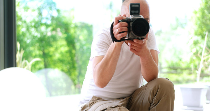 Photographer takes pictures with DSLR camera