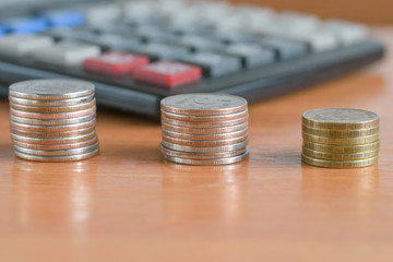 Coins and calculator on the table surface.