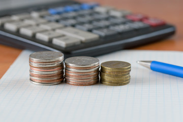 Coins and calculator on the table surface.
