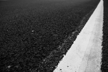 Fototapeta premium Asphalt road line white texture close up.