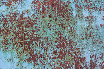 Blue cracked painting on metal surface