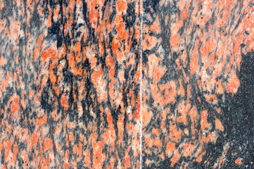 Facing wall of curly pieces of marble. Basement of the building