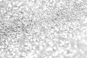 Sillver bokeh texture. Festive glitter background with defocused lights