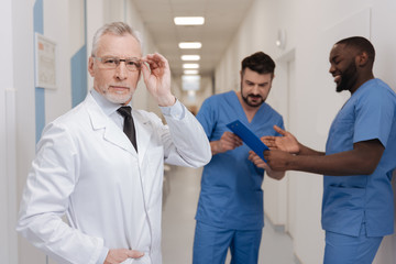 Charismatic aging medic demonstrating confidence at work