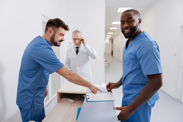 Obraz premium Positive practitioners working in the clinic