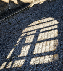 shadow of girls in the arc of the arch on the cobblestones of the ancient city