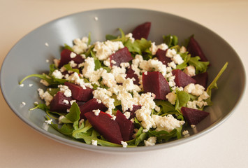 Beetroot salad with green rucola plant and cottage cheese