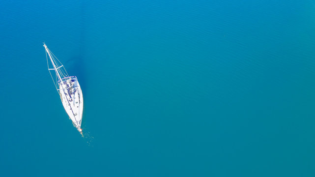 White yacht in the blue sea, top view