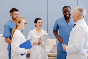 Elderly mentor enjoying teaching interns in medical university