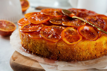 Candied red orange cake on a light background. Selective focus.