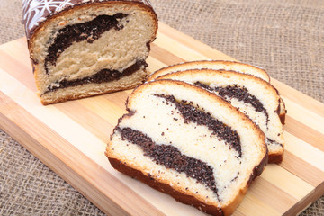 Fresh baked homemade sweet pies, strudel with poppy-seed filling on wooden board.