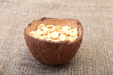 Roasted peeled peanuts in Handmade bowl of coconut, Selective Focus