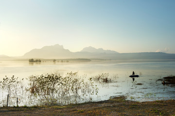 fisherman fishing in big lake