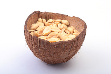 Roasted peeled peanuts in Handmade bowl of coconut, Selective Focus
