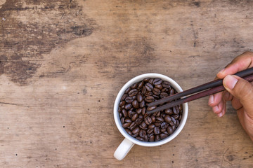 cup of coffee, coffee beans, Wooden chopsticks on wooden table