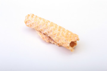 Homemade wafer rolls with powdered sugar isolated on white background