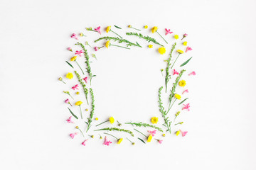 Flowers composition. Frame made of yellow and pink flowers on white background. Flat lay, top view