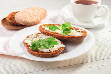 Rye bread with soft cheese and greens