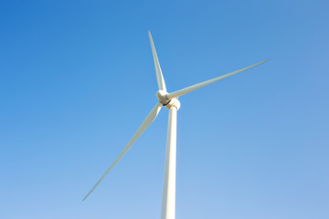 Wind turbines generating electricity with blue sky - energy conservation concept