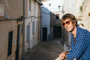 Obraz na płótnie Canvas Young stylish male in sunglasses posing