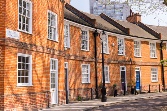 Classic British crescent with restored Victorian red brick houses on a local road in Denny Crescent, Kennington, Lambeth London