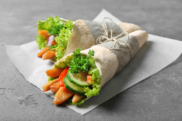 Delicious kebab sandwiches on grey table