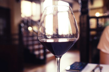 Serving a glass of red wine in a restaurant