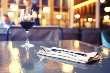 Serving a glass of red wine in a restaurant
