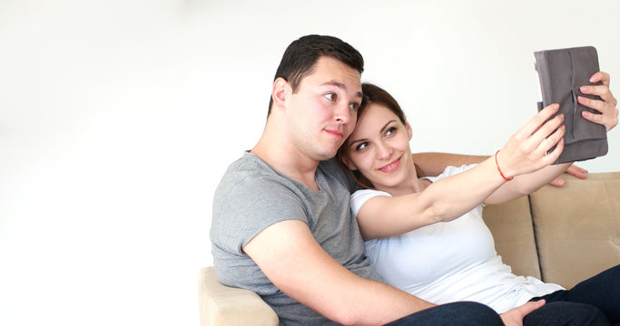 Young Couple using digital tablet at home